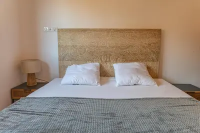 a bedroom with a bed with two pillows on it at Villa Campemu Di Lecci in Lecci