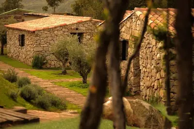 a stone building with a pathway next to it at Bergerie du Prunelli in Cauro