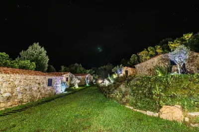 a night view of an old stone building at Bergerie du Prunelli in Cauro