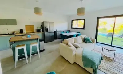 a small bedroom with a bed and a table at Villa Lagon Bleu- Piscine privée- Corsu di Core in Favone