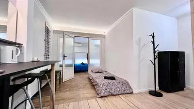 a kitchen with white walls and a table in a room at Coliving Ajaccio in Ajaccio