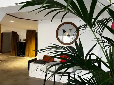 a bedroom with a mirror and a plant at Coliving Ajaccio in Ajaccio