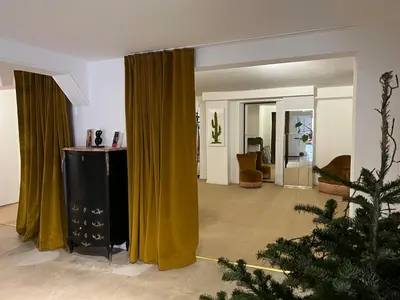 a living room with yellow curtains and a christmas tree at Coliving Ajaccio in Ajaccio