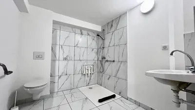 a white bathroom with a sink and a toilet at Coliving Ajaccio in Ajaccio