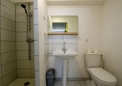 a bathroom with a toilet and a sink and a shower at Coliving Ajaccio in Ajaccio