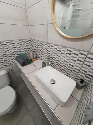a bathroom with a white sink and a mirror at studio cosy idéalement situé parking privé in Ajaccio