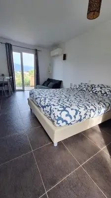 a bedroom with a bed and a view of the ocean at Résidence Dolce Vita in Propriano