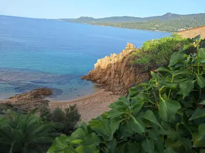 a view of the ocean and a rocky beach at Résidence Dolce Vita in Propriano