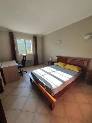 a bedroom with a bed and a desk in it at Rez de villa in Borgo