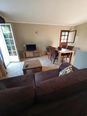 a living room with a couch and a table at Rez de villa in Borgo