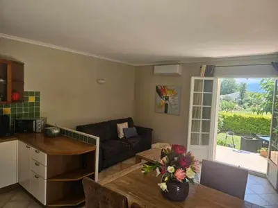a living room with a couch and a table at Rez de villa in Borgo
