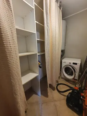 a room with a closet with a washing machine at Rez de villa in Borgo