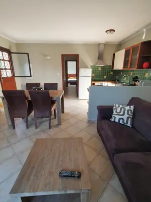 a living room with a couch and a table at Rez de villa in Borgo