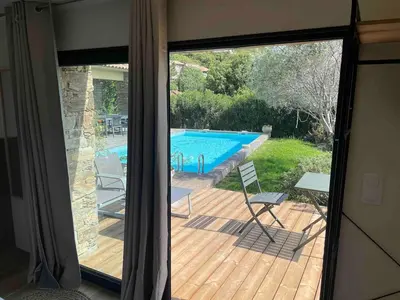 a view of a swimming pool through a sliding glass door at A Casetta Di Oletta in Oletta