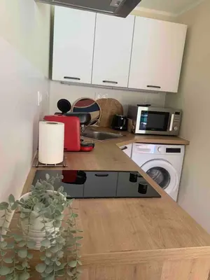 a kitchen with a counter with a sink and a washing machine at A Casetta Di Oletta in Oletta
