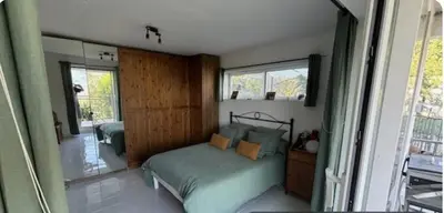 a bedroom with a bed and a mirror at Appartement en Corse in Noceta