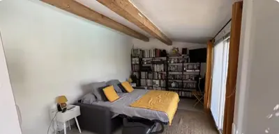 a bedroom with a bed and a book shelf at Appartement en Corse in Noceta