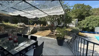 a patio with a table and a fence at Appartement en Corse in Noceta