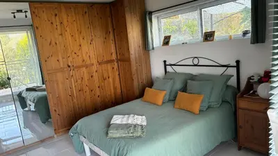 a bedroom with a bed with green and orange pillows at Appartement en Corse in Noceta