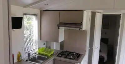 a small kitchen with a sink and a stove at Ferme de Chiuni in Cargèse