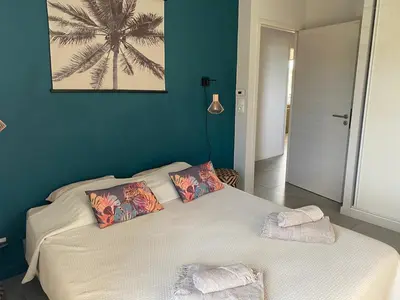 a bedroom with a bed with two pillows on it at T3 Tout confort à 5 mn des plages de Pinarello in Pinarellu
