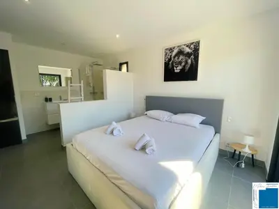 a bedroom with a bed and a large window at Architect's Villa - 10-12 people - Pool - 4 bedrooms in Zonza