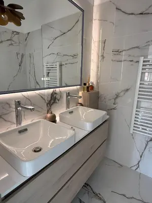 a white bathroom with a sink and a mirror at Appartement de luxe type 4 Eden Suite Sanguinaires vue mer avec piscine chauffée résidence Ajaccio in Ajaccio