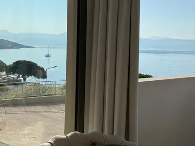 a view of the ocean from a room with a window at Appartement de luxe type 4 Eden Suite Sanguinaires vue mer avec piscine chauffée résidence Ajaccio in Ajaccio