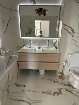 a bathroom with a sink and a mirror and a toilet at Appartement de luxe type 4 Eden Suite Sanguinaires vue mer avec piscine chauffée résidence Ajaccio in Ajaccio