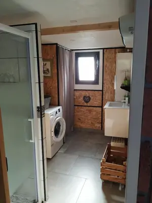 a small bathroom with a washing machine and a sink at L'Attellu Di Babbu pour 2 in Lecci