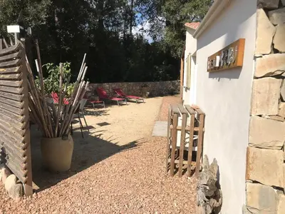 a side yard with chairs and a building at L'Attellu Di Babbu pour 2 in Lecci