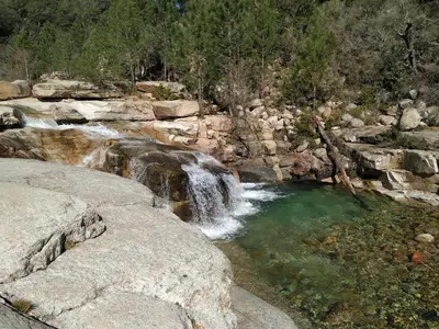a pool of water in a river with rocks at L'Attellu Di Babbu pour 2 in Lecci