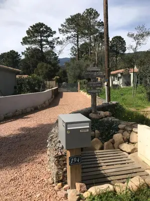 a street sign and a mailbox on a road at L'Attellu Di Babbu pour 2 in Lecci