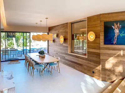 a dining room with a table and chairs at Villa L'Immortelle in Lecci