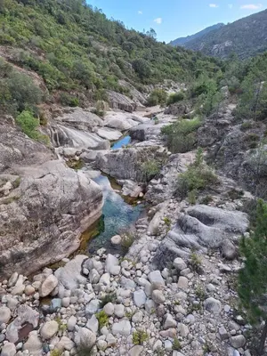 a river in the middle of a rocky canyon at Villa Résidence San Martinu Sainte Lucie De Porto Vecchio in Zonza