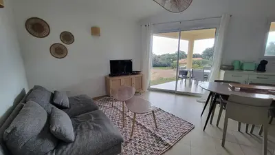 a living room with a couch and a table at Villa Résidence San Martinu Sainte Lucie De Porto Vecchio in Zonza