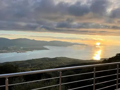 a view of a body of water at sunset at Maison avec vue imprenable in Olmeto
