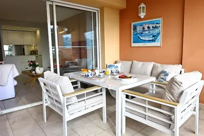 a kitchen with white cabinets and white counter tops at Les Sanguinaires N'7 - T2 Vue Mer, Piscine & Plage in Ajaccio