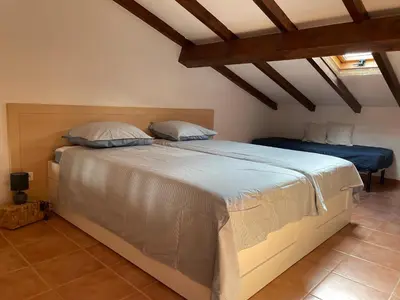 a bedroom with a large bed in a room at Appartement T2 vue mer, piscine Linguizzetta Bravone in Linguizzetta