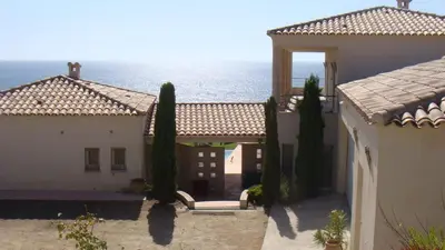 a view of the ocean from between two buildings at Casamea - Sagone, Villa Vue Mer, Clim, Piscine in Coggia