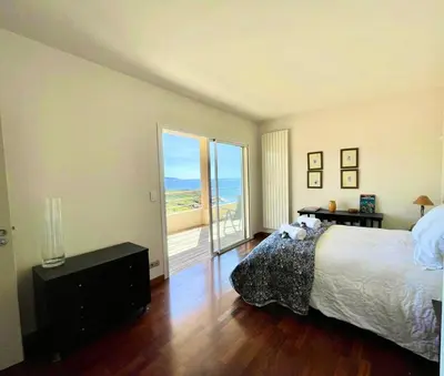 a bedroom with a bed and a view of the ocean at Casamea - Sagone, Villa Vue Mer, Clim, Piscine in Coggia
