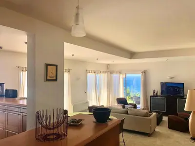 a living room with a couch and a table at Casamea - Sagone, Villa Vue Mer, Clim, Piscine in Coggia