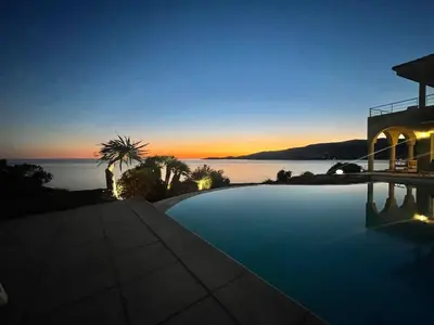 a swimming pool with a view of the ocean at dusk at Casamea - Sagone, Villa Vue Mer, Clim, Piscine in Coggia