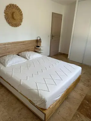a large white bed in a room with at villa avec jacuzzi privé proche plage in Solaro