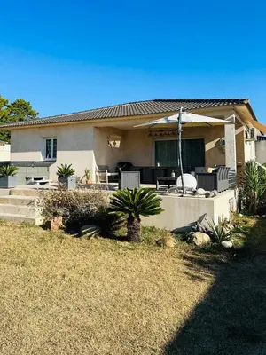a house with a porch and a patio at villa avec jacuzzi privé proche plage in Solaro