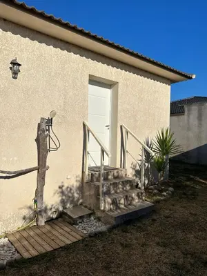 a staircase leading to a house with a white door at villa avec jacuzzi privé proche plage in Solaro