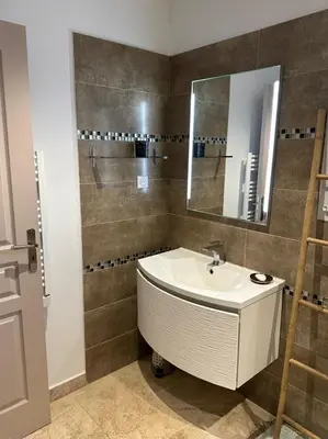 a bathroom with a sink and a mirror at villa avec jacuzzi privé proche plage in Solaro