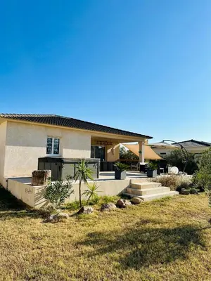 a house with a lawn in front of it at villa avec jacuzzi privé proche plage in Solaro