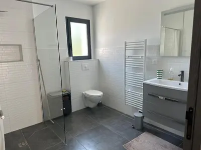 a bathroom with a toilet and a sink and a shower at Villa avec piscine privée Santa Maria Poggio in Santa-Maria-Poggio