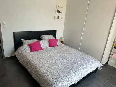a bedroom with a bed with two pink pillows at Villa avec piscine privée Santa Maria Poggio in Santa-Maria-Poggio